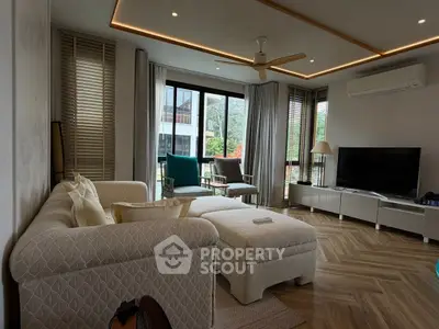 Luxurious living room with modern decor, large windows, and stylish furniture in a contemporary home.