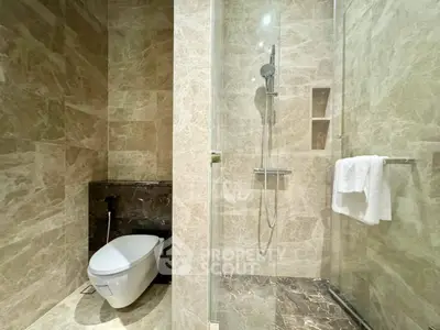Luxurious marble bathroom with a spacious walk-in shower and modern fixtures, offering a serene and elegant space for relaxation.