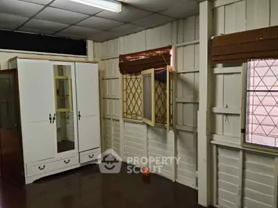 Charming vintage room with wooden walls and classic wardrobe