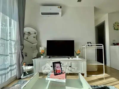 Modern living room with air conditioning, TV, and stylish decor in a bright apartment.