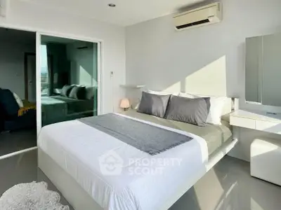 Modern bedroom with sleek design and natural light, featuring a comfortable bed and air conditioning.