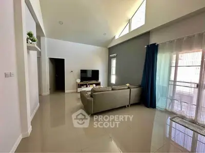 Spacious modern living room with high ceilings and natural light