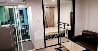 Modern studio apartment with glass partition, cozy living area, and balcony access.