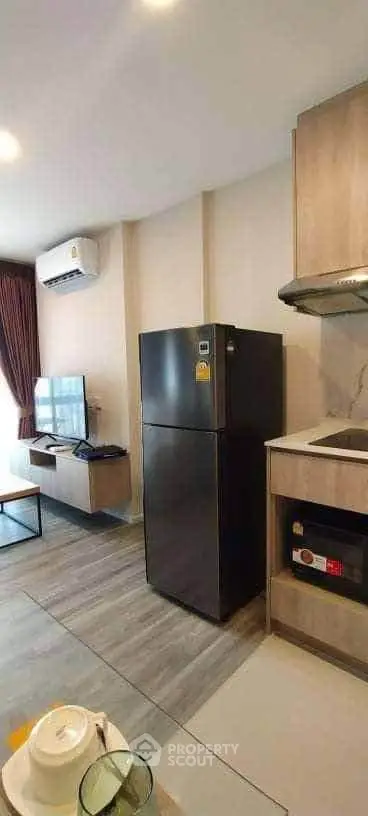 Modern kitchen with sleek appliances and open layout in stylish apartment.