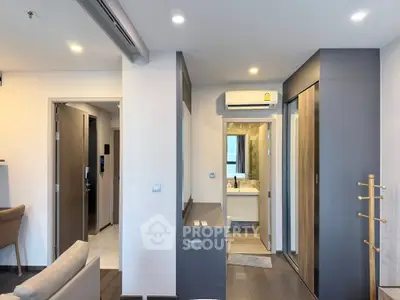 Modern apartment interior with open layout and sleek design, featuring a cozy living area and stylish bathroom.