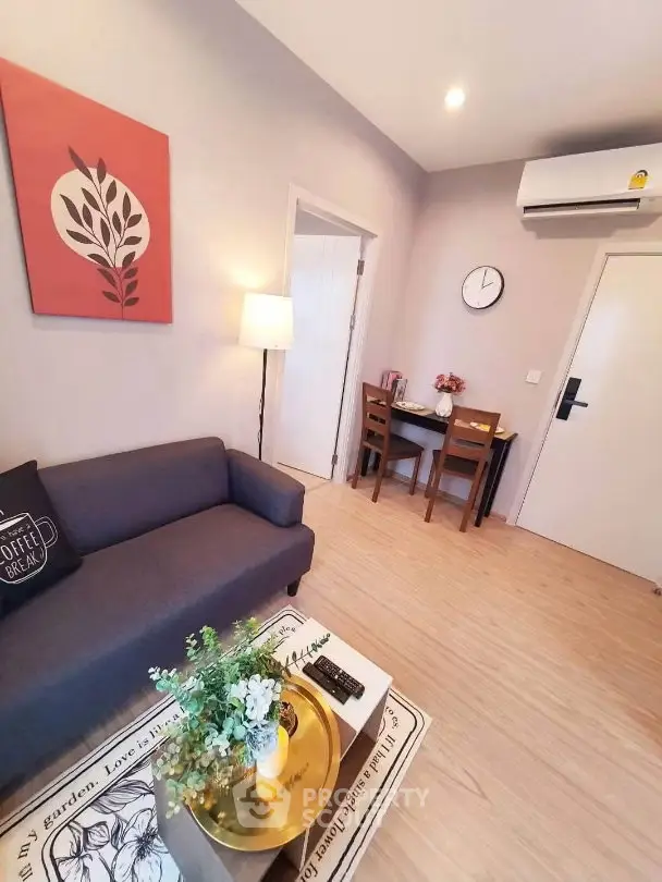 Cozy living room with modern decor and air conditioning, perfect for relaxation.