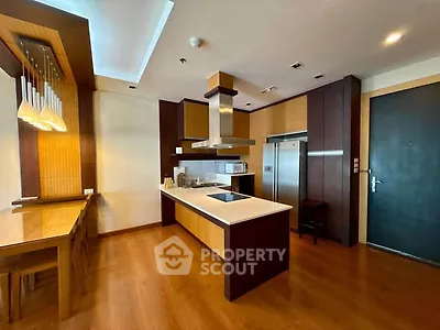 Modern kitchen with sleek wooden cabinetry and island in luxury apartment