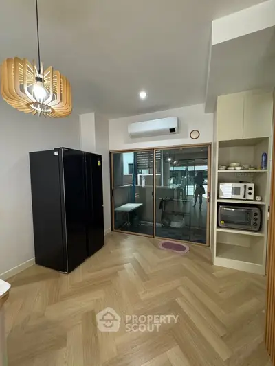 Modern kitchen with sleek appliances and stylish lighting