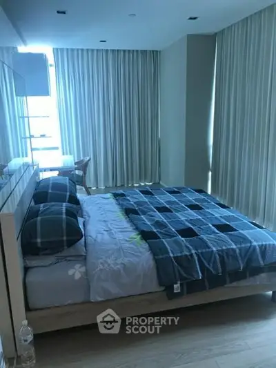 Cozy bedroom with modern decor and large windows for natural light