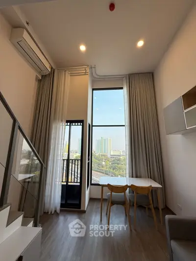 Modern high-ceiling living room with large windows and city view