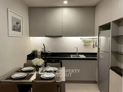 Modern kitchen with sleek cabinets and dining area, perfect for urban living.