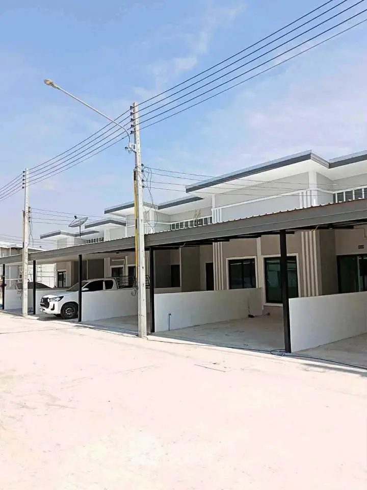 Modern townhouse exterior with carport and clean architectural lines.
