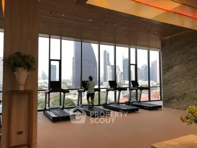 Luxurious gym with city skyline view and modern treadmills in high-rise building
