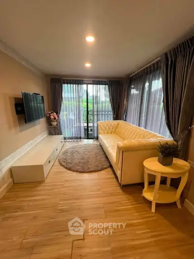 Charming living room with elegant decor and large windows offering natural light.