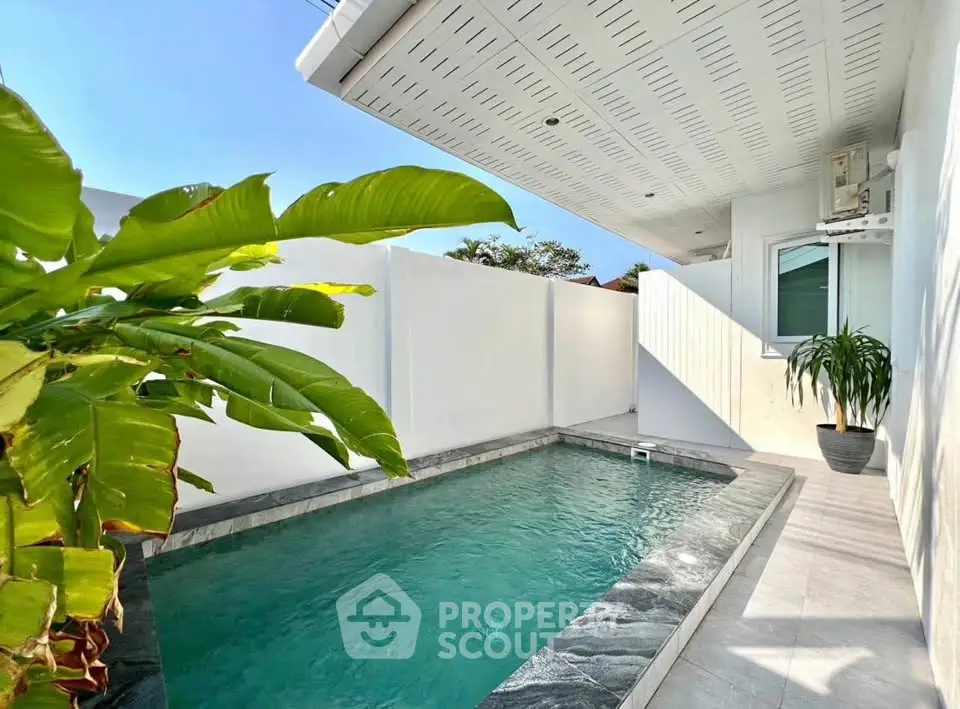 Charming private pool area with modern design and lush greenery, perfect for relaxation and entertainment.