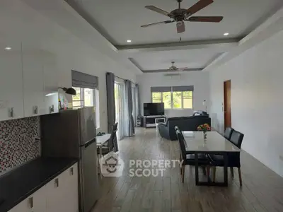 Spacious open-plan living and dining area with modern kitchen and stylish decor.