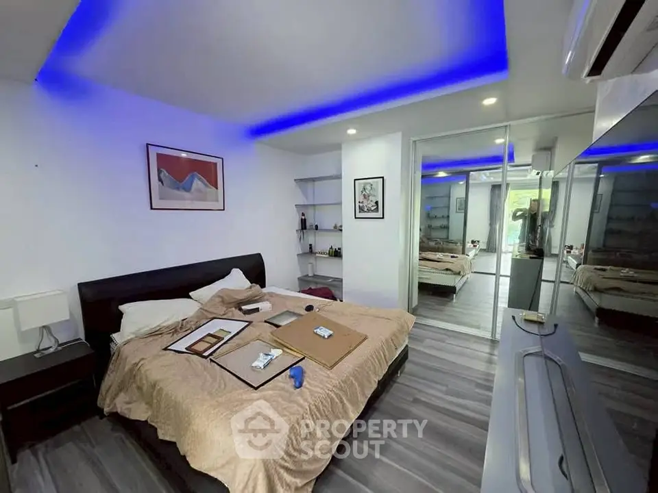 Modern bedroom with sleek design and ambient lighting