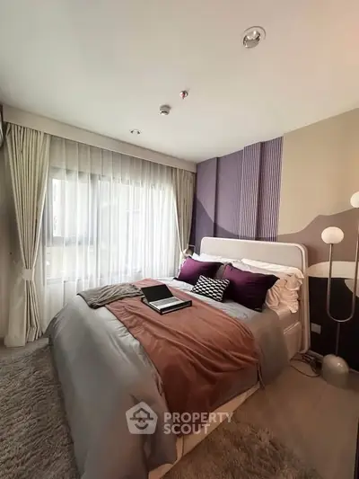 Luxurious bedroom with modern decor and plush bedding in a stylish apartment.