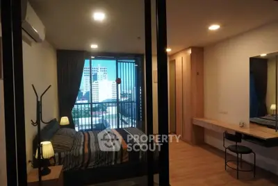 Modern bedroom with city view, stylish decor, and ample natural light