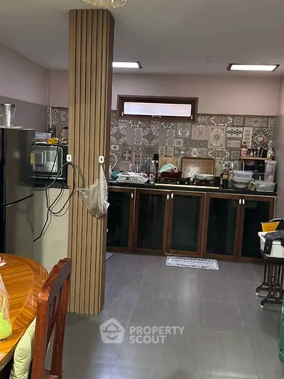 Spacious kitchen with modern appliances and stylish backsplash tiles.