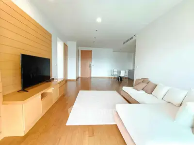 Spacious modern living room with wooden flooring and stylish furniture