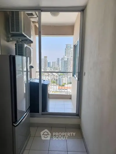 Modern apartment balcony with city skyline view and air conditioning units.