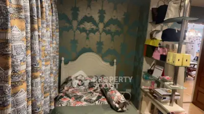 Charming bedroom with stylish wallpaper and cozy bed, perfect for a restful retreat.
