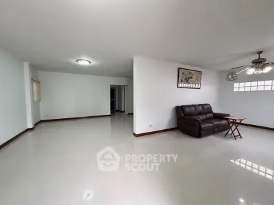 Spacious living room with modern decor and comfortable seating in a bright apartment.