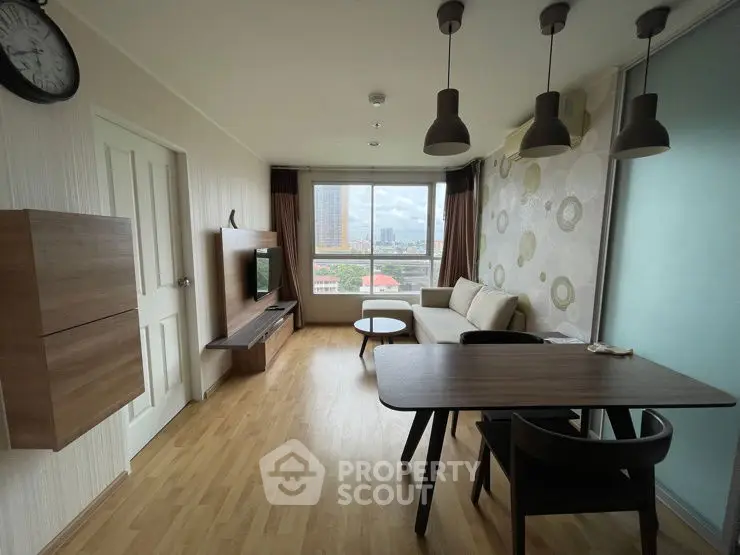 Modern living room with wooden flooring, stylish furniture, and city view from large window.