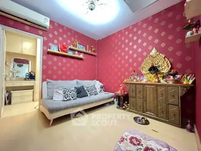 Cozy living room with vibrant red walls and elegant decor