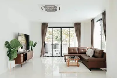Spacious modern living room with large windows and stylish furniture