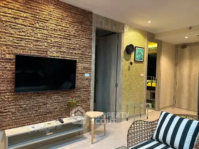 Stylish living room with modern decor and wall-mounted TV in a cozy apartment.