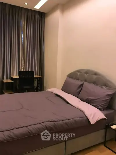 Cozy bedroom with plush bed and study desk, ideal for restful nights and productive days.