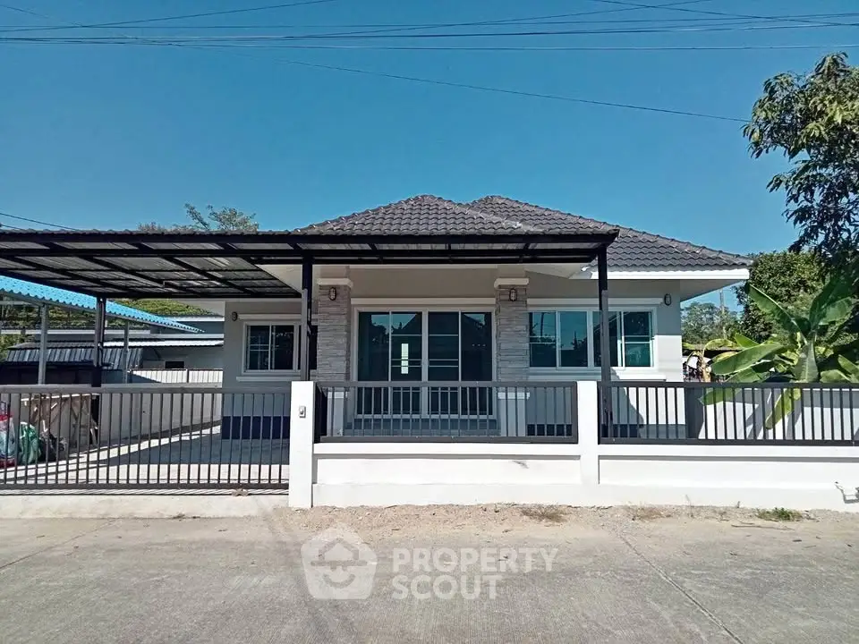 Charming single-story home with modern design and spacious front yard in a serene neighborhood.