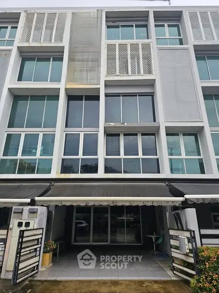 Modern multi-story building with large windows and sleek facade