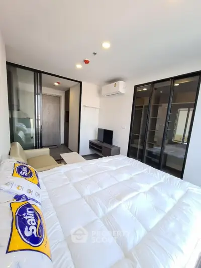 Modern bedroom with glass sliding doors and cozy furnishings