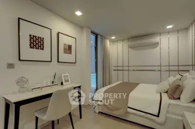 Modern bedroom with stylish decor and workspace, featuring elegant lighting and cozy ambiance.