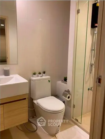 Modern bathroom with sleek fixtures and glass shower enclosure