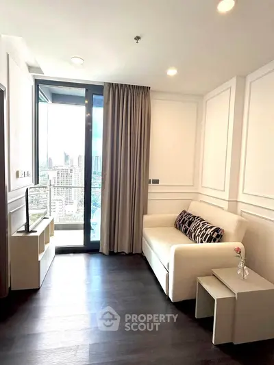 Modern living room with city view, featuring sleek furniture and large windows for natural light.