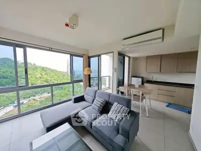 Spacious living room with stunning view and modern kitchen in open layout apartment.