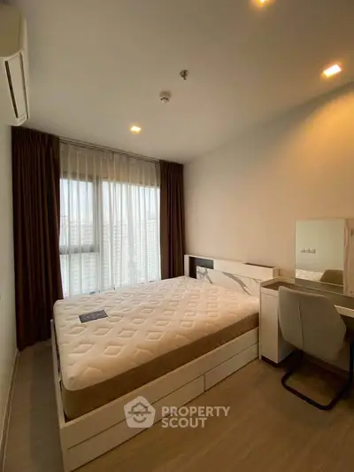 Modern bedroom with large window and stylish furniture in a high-rise apartment.