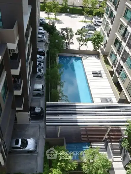 Modern condominium with pool view and parking area, ideal urban living.