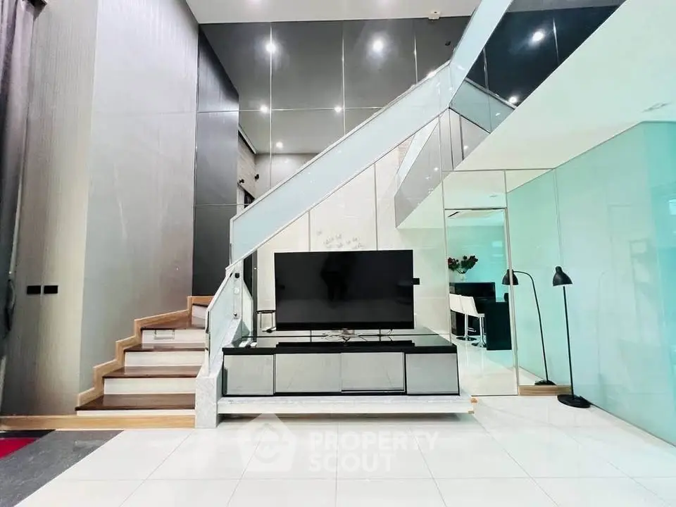 Modern duplex living room with sleek staircase and stylish decor