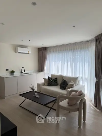 Modern living room with open kitchen and stylish furniture