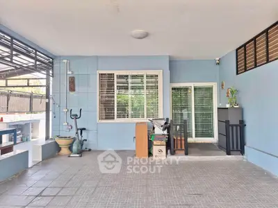 Spacious covered patio with exercise equipment and modern decor