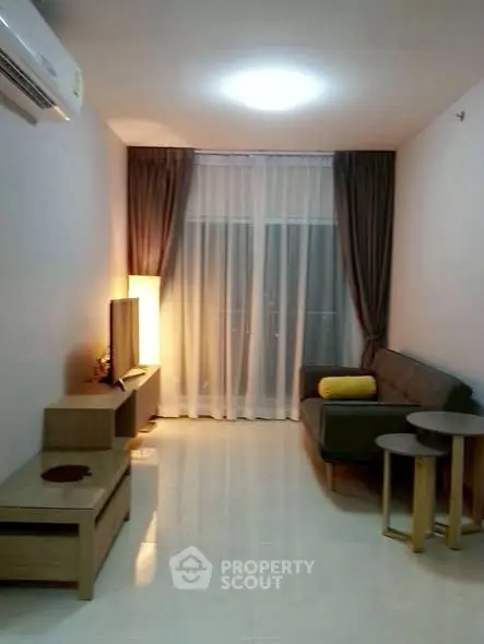 Cozy living room with modern furniture and ambient lighting, perfect for relaxation.