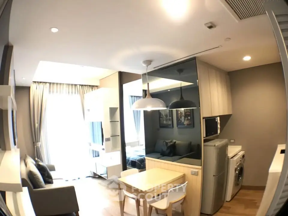Modern living room with stylish furniture and built-in appliances in a cozy apartment.
