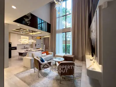 Luxurious double-height living room with modern decor and large windows offering garden views.