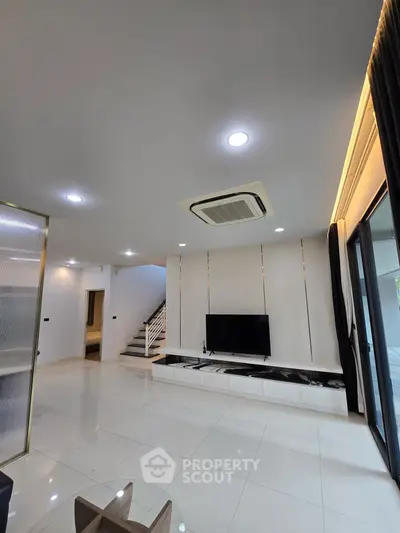 Spacious modern living room with sleek design and ample natural light