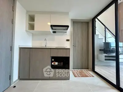 Modern kitchen with sleek cabinetry and built-in appliances in a stylish apartment.